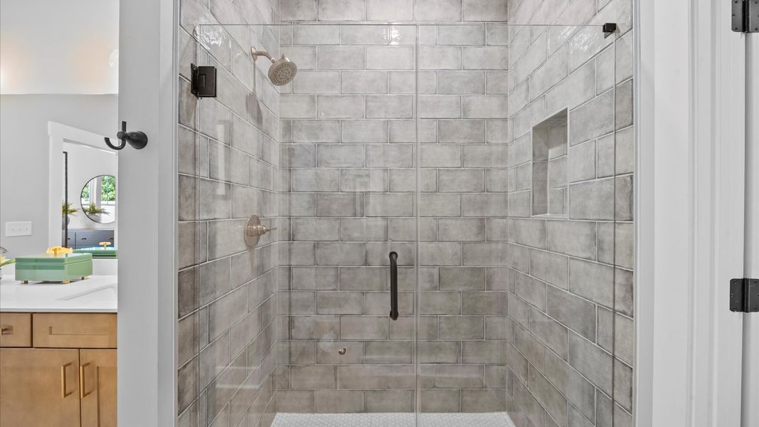 Sophisticated primary bathroom with a glass walk-in shower and polished hardware located in Fountain Inn, SC