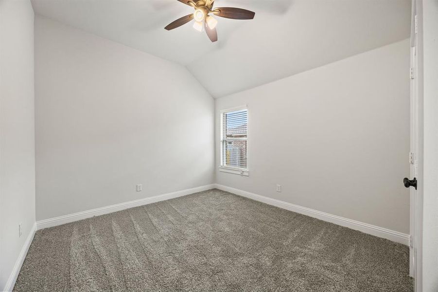 Unfurnished room with carpet, lofted ceiling, and ceiling fan