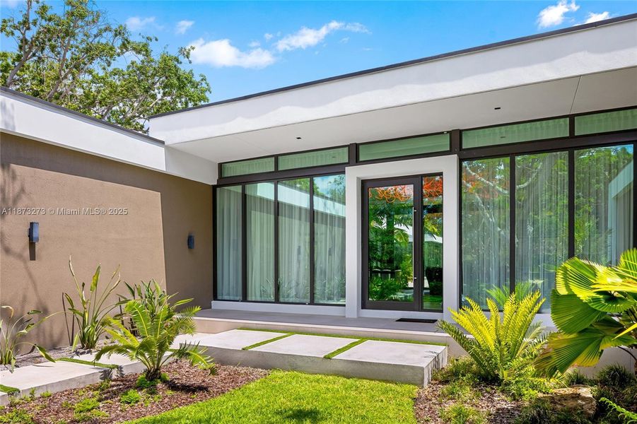 Front exterior of a new home in , Pinecrest, FL, highlighting curb appeal (Image 28).