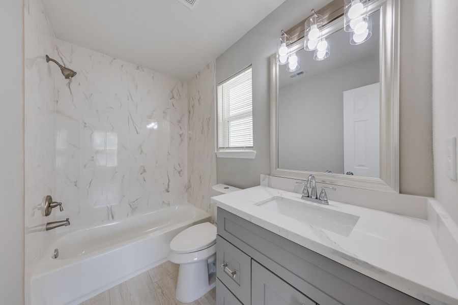 The secondary full bath features a convenient shower-tub combo, offering versatility for both quick showers and relaxing baths.