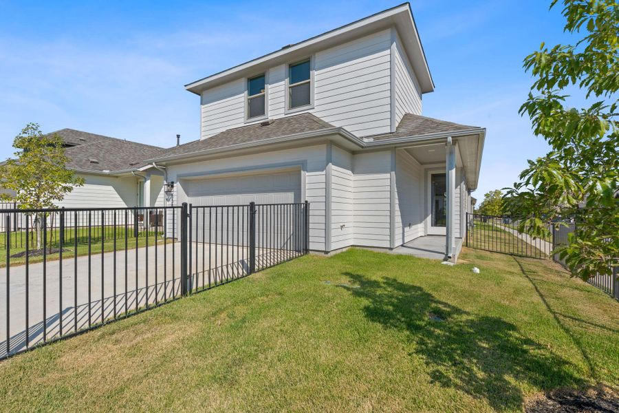 View of front of house featuring roof with shingles, driveway, and a patio View of front of house featuring roof with shingles, driveway, and a patio