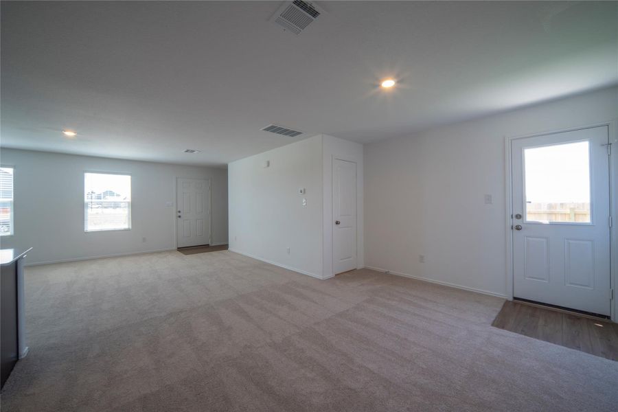 Foyer featuring light carpet and recessed lighting