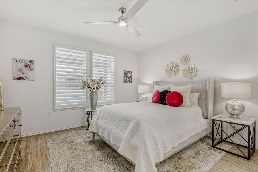 Bedroom with light wood finished floors and ceiling fan