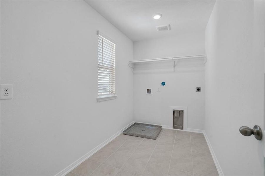 The Utility Room is spacious for your washer & dryer appliances and has a high shelf for all your laundering supplies.