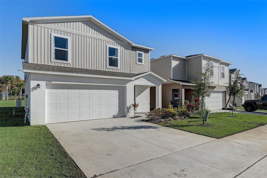 Front exterior of a new home in Bradbury Creek, Haines City, FL, highlighting curb appeal (Image 2). Front exterior of a new home in Bradbury Creek, Haines City, FL, highlighting curb appeal (Image 2).