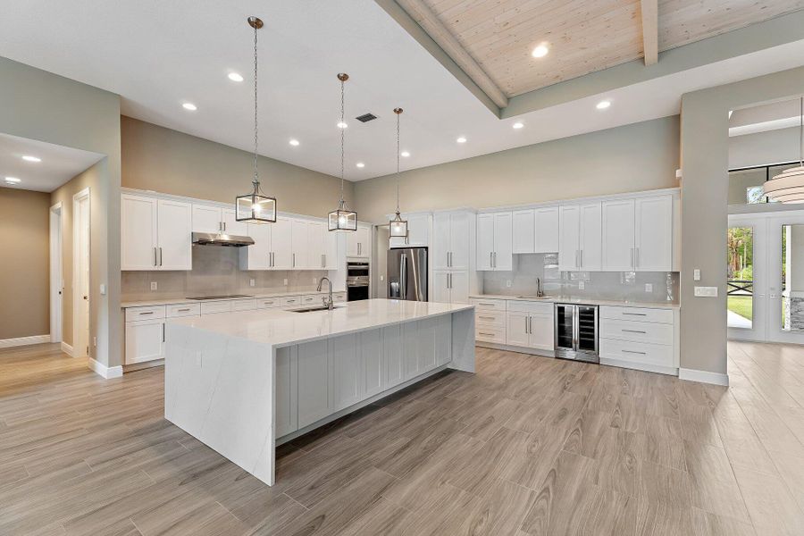 Spacious waterfall island, wine fridge and bar sink perfect for hosting