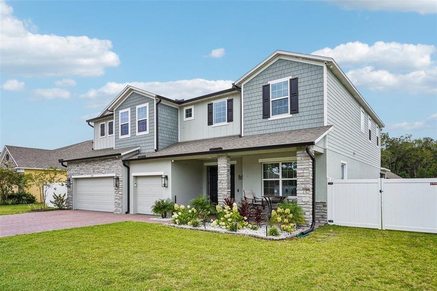 Front exterior of a new home in Elegant Manor Estates, Edgewater, FL, highlighting curb appeal (Image 26). Front exterior of a new home in Elegant Manor Estates, Edgewater, FL, highlighting curb appeal (Image 26).