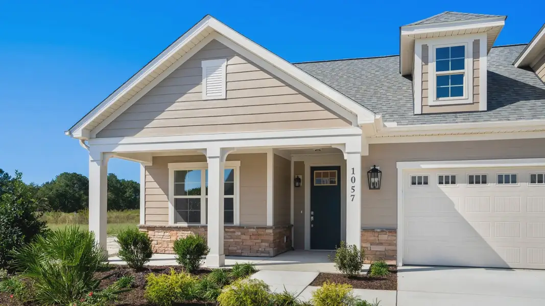 Front exterior of a new home in Courtyards by Carrell, Ocean Isle Beach, NC, highlighting curb appeal (Image 2). Front exterior of a new home in Courtyards by Carrell, Ocean Isle Beach, NC, highlighting curb appeal (Image 2).