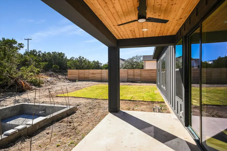 Fenced backyard featuring a patio and a ceiling fan