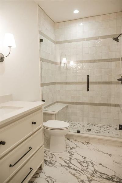 Bathroom featuring vanity, a shower stall, and recessed lighting Bathroom featuring vanity, a shower stall, and recessed lighting