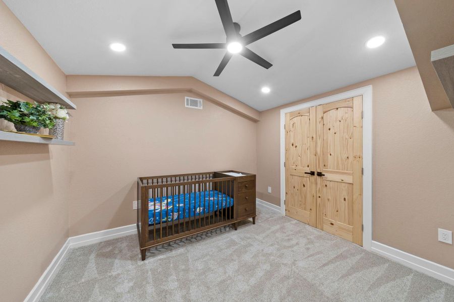 Additional upstairs cozy bedroom anchored by beautiful, double natural-wood doors.