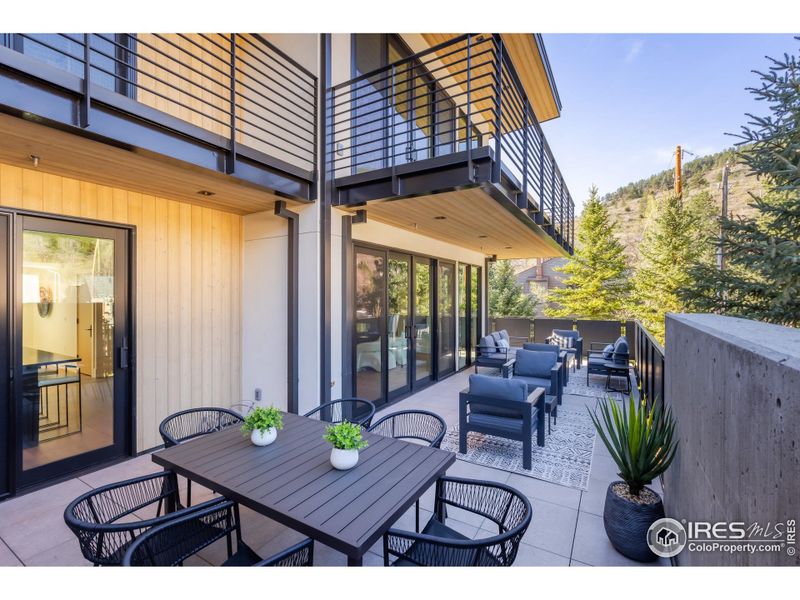The expansive west-facing balcony lives like an additional outdoor room, with space for living, al fresco dining and cooking.
