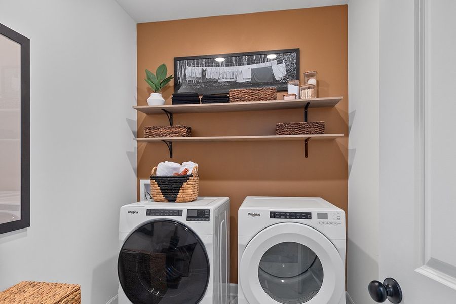 A room with a shelf and a washing machine. A room with a shelf and a washing machine.