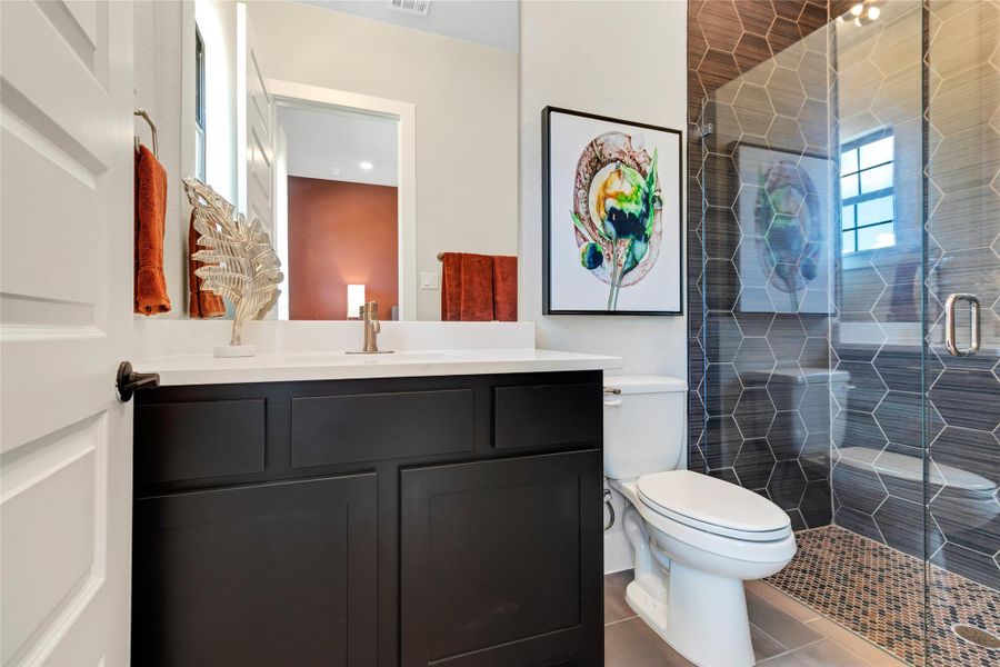 Bathroom with tile patterned floors, vanity, and a stall shower Bathroom with tile patterned floors, vanity, and a stall shower