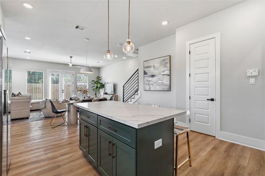 An open kitchen and dining layout where scale and flow come together, anchored by a central island and a dining area that comfortably seats six. An open kitchen and dining layout where scale and flow come together, anchored by a central island and a dining area that comfortably seats six.