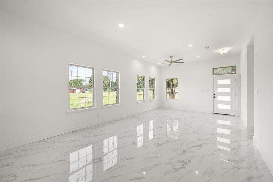 Unfurnished room featuring recessed lighting, light marble finish floors, and a ceiling fan Unfurnished room featuring recessed lighting, light marble finish floors, and a ceiling fan
