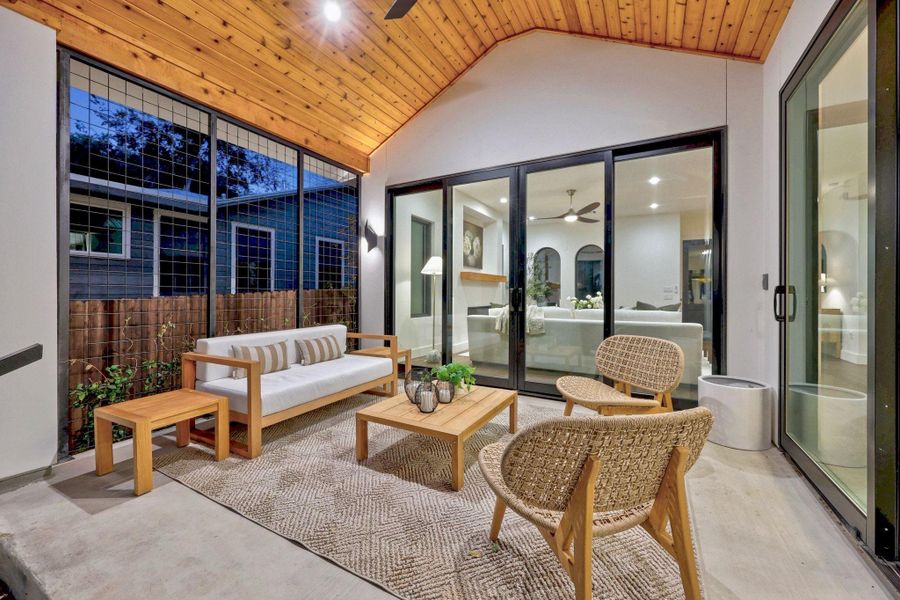 Covered patio featuring a sloped wood-paneled ceiling, recessed lighting, and a ceiling fan