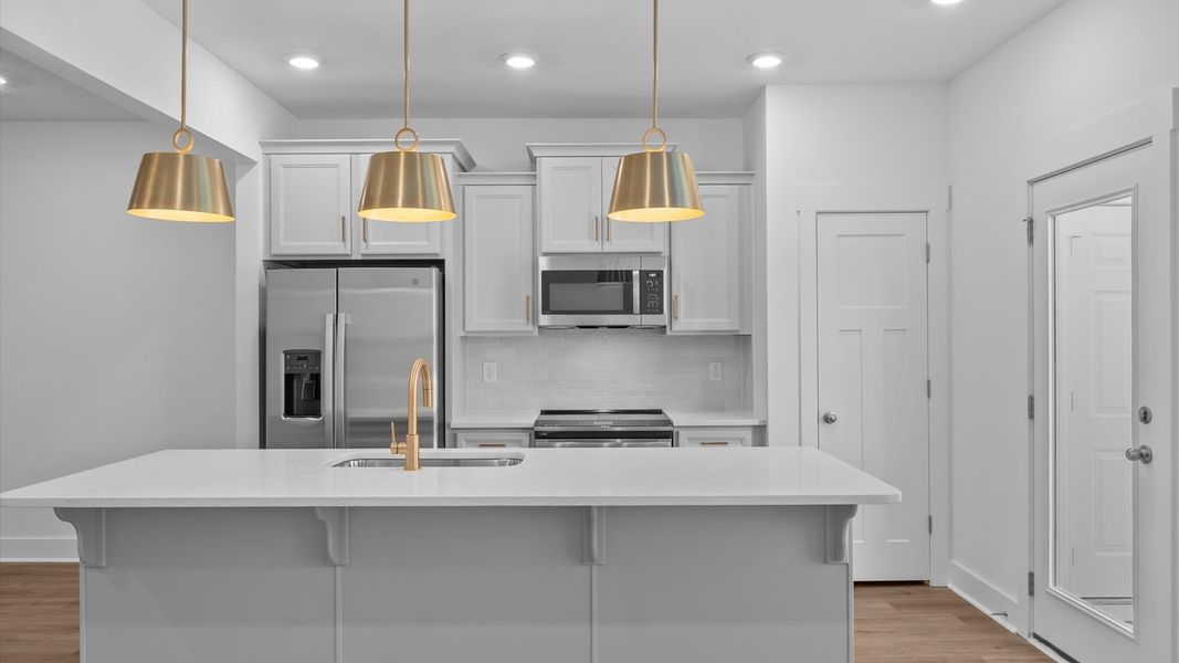 Exceptional kitchen featuring a spacious island, eye-catching pendant lights, and modern finishes in Simpsonville, SC