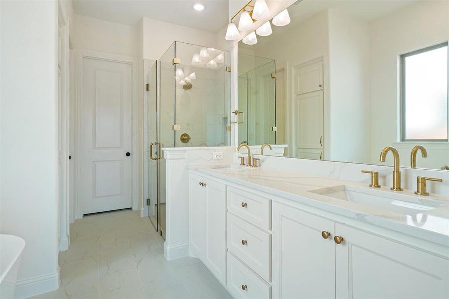 Full bathroom with a shower stall, double vanity, marble finish flooring, and a freestanding bath Full bathroom with a shower stall, double vanity, marble finish flooring, and a freestanding bath