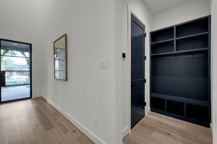 Mudroom area with built-in storage and modern finishes. Mudroom area with built-in storage and modern finishes.