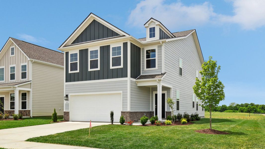 Home exterior with two tone blue siding and 2-car garage
