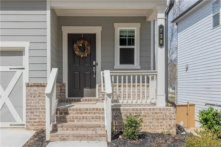Exterior details and patio area of a home in Creekside at Farmers Crossing, Ball Ground (Image 3).