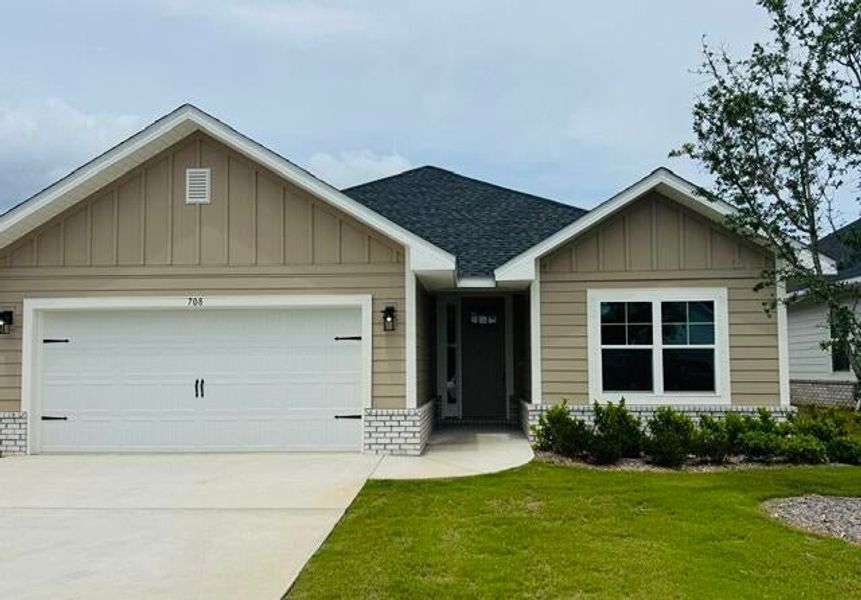 Front exterior of a new home in The Bluffs at Lafayette, Freeport, FL, highlighting curb appeal (Image 1). Front exterior of a new home in The Bluffs at Lafayette, Freeport, FL, highlighting curb appeal (Image 1).