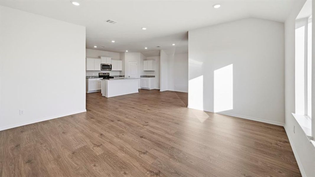 Unfurnished living room with recessed lighting and dark wood-type flooring Unfurnished living room with recessed lighting and dark wood-type flooring