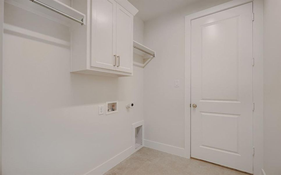 Laundry area featuring neutral wall paint, white baseboards, and light-colored flooring