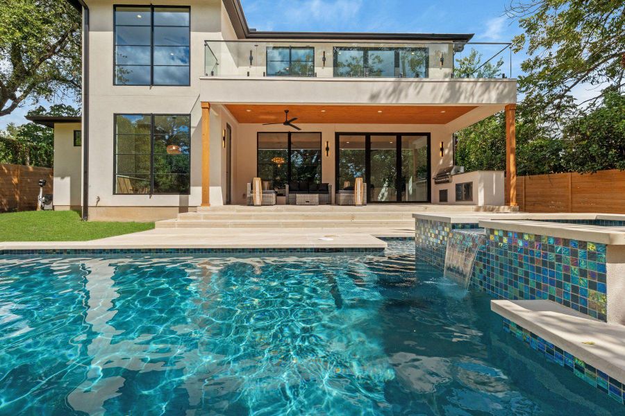 Clean lines and warm wood accents define this modern backyard retreat with an integrated spa.