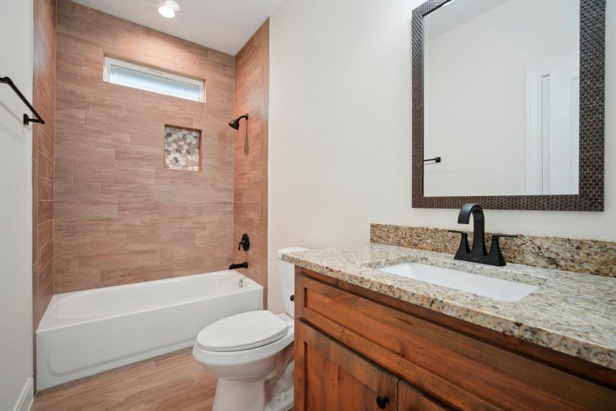 Full bathroom with vanity, toilet, shower / bathtub combination, and wood finished floors