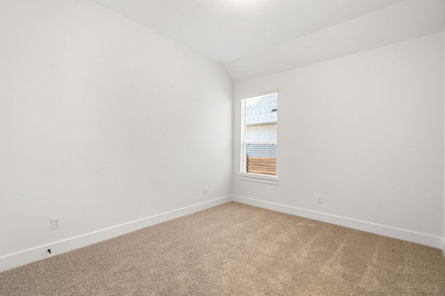 A  bedroom features window with blinds, creating a comfortable personal retreat.