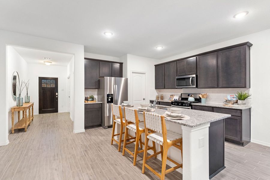 A kitchen with a wood floor. A kitchen with a wood floor.
