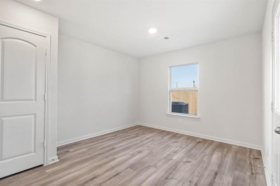 Unfurnished room featuring light wood-type flooring