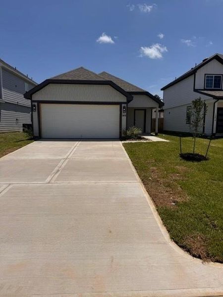 Front exterior of a new home in Townsend Reserve, Splendora, TX, highlighting curb appeal (Image 2).