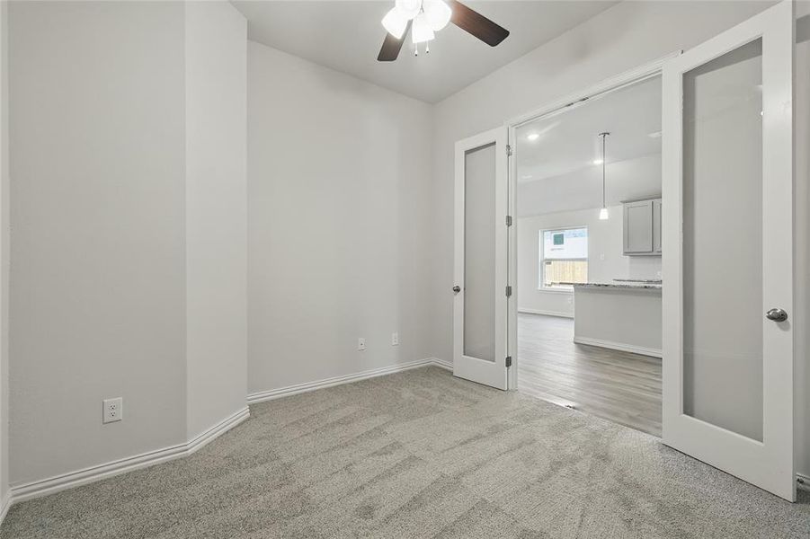 Unfurnished room with light carpet and ceiling fan