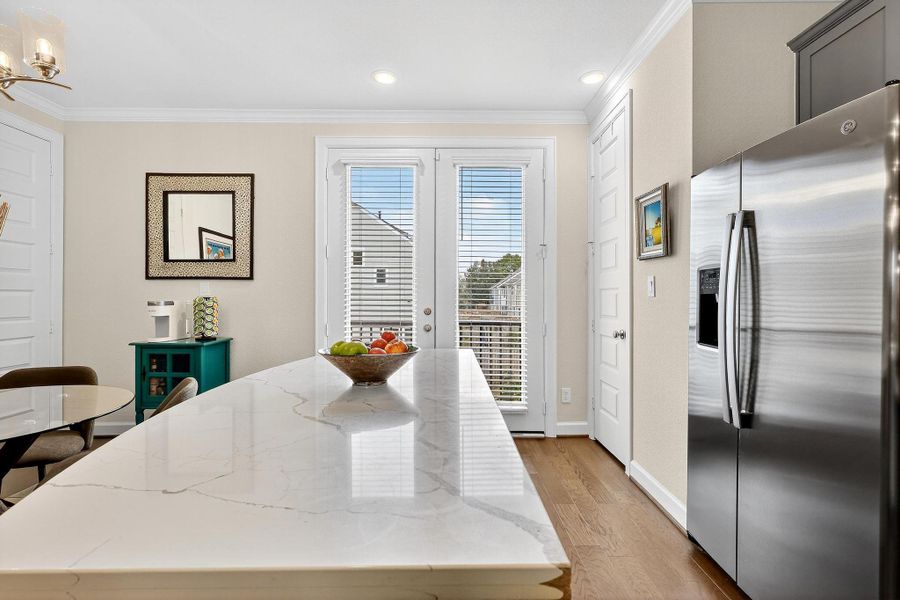 Bright kitchen with access to the balcony through French doors, allowing abundant natural light and seamless indoor-outdoor flow. Bright kitchen with access to the balcony through French doors, allowing abundant natural light and seamless indoor-outdoor flow.