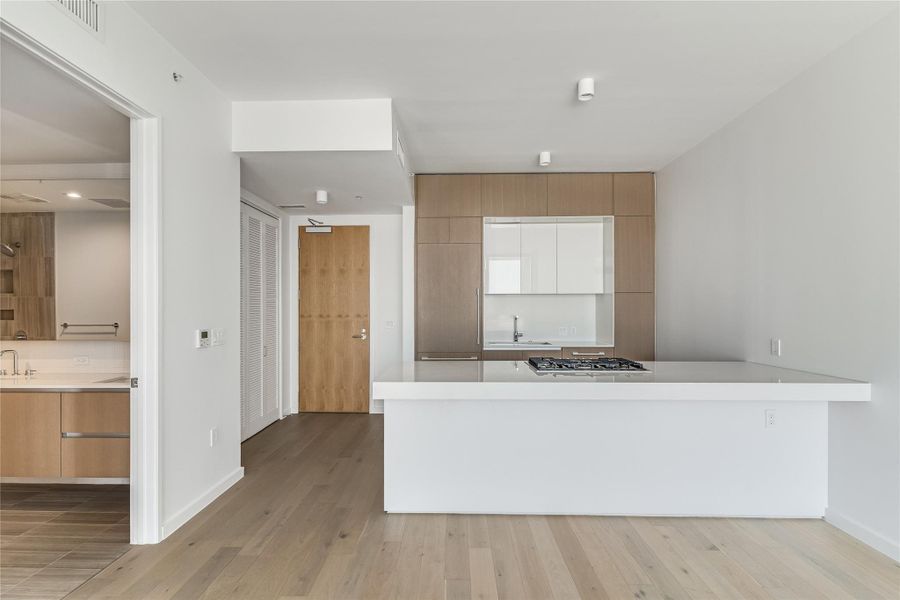 A streamlined kitchen island offers functional space and modern aesthetic in this open layout. A streamlined kitchen island offers functional space and modern aesthetic in this open layout.