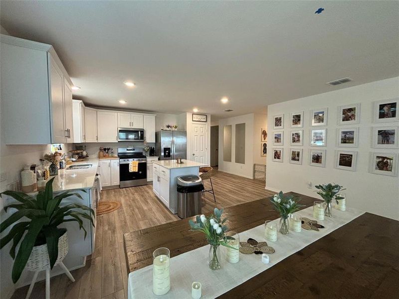 Dining area with light wood-type flooring and recessed lighting