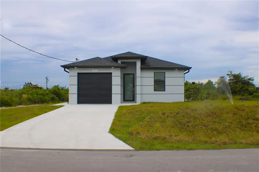 Front exterior of a new home in , Lehigh Acres, FL, highlighting curb appeal (Image 21).