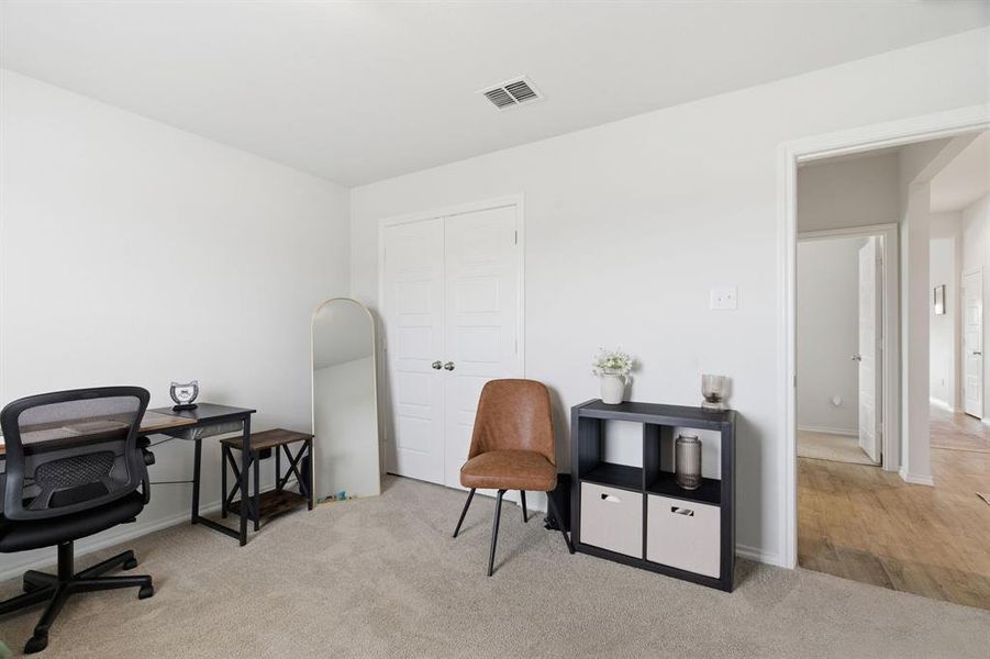Home office with light colored carpet