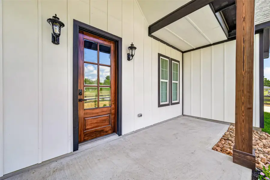 Welcoming covered porch creates a charming outdoor entry space.