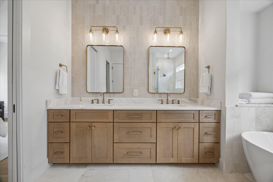 Primary bathroom, marble countertops, natural stone tile.
