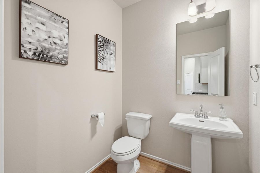 Stylish powder room featuring a pedestal sink, contemporary fixtures, and modern finishes. Stylish powder room featuring a pedestal sink, contemporary fixtures, and modern finishes.
