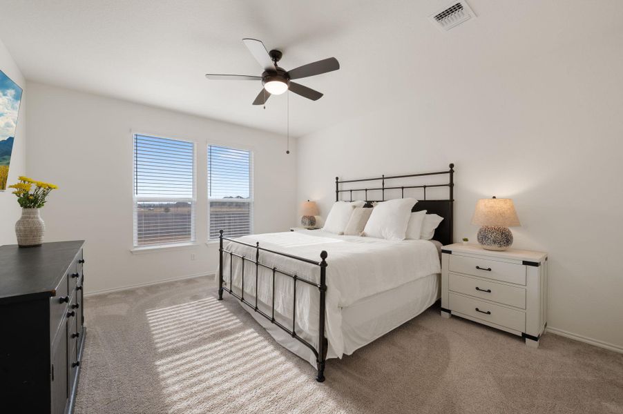 Bedroom featuring light carpet and a ceiling fan