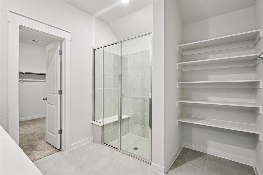 Bathroom featuring tile patterned floors and an enclosed shower