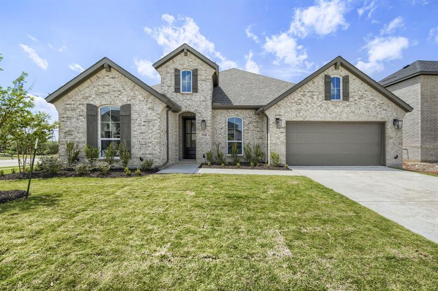 Brick exterior with architectural shingles and arched window details Brick exterior with architectural shingles and arched window details