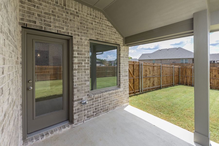 Exterior details and patio area of a home in Keeneland, Aubrey (Image 3).