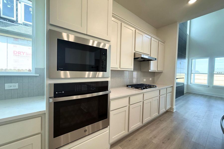 Culinary delights await in this bright kitchen, complete with modern appliances and ample counter space. Culinary delights await in this bright kitchen, complete with modern appliances and ample counter space.