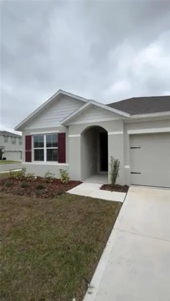 Front exterior of a new home in Villamar by Express Homes, Winter Haven, FL, highlighting curb appeal (Image 8).